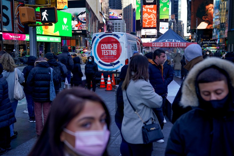 People wait in a long line to get tested for COVID-19 in Times Square, New York, on Dec. 20, 2021. (AP Photo/Seth Wenig, file)