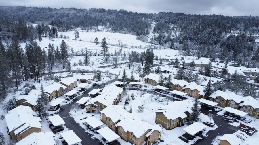 Glenbrook Basin and Loma Rica Ranch remain covered in about a foot of snowfall, Tuesday, Dec. 28, 2021, in Grass Valley, Calif. Snow, ice and unseasonable cold in the Pacific Northwest and the Sierra Nevada are continuing to disrupt traffic, cause closures and force people to find refuge in emergency warming shelters. (Elias Funez/The Union via AP)