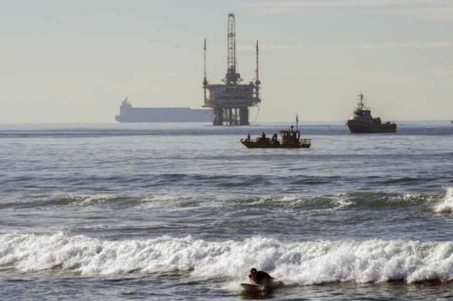 Boats survey the waters on Dec. 16 after an earlier oil sheen was spotted off Bolsa Chica State Beach.(Irfan Khan/Los Angeles Times)