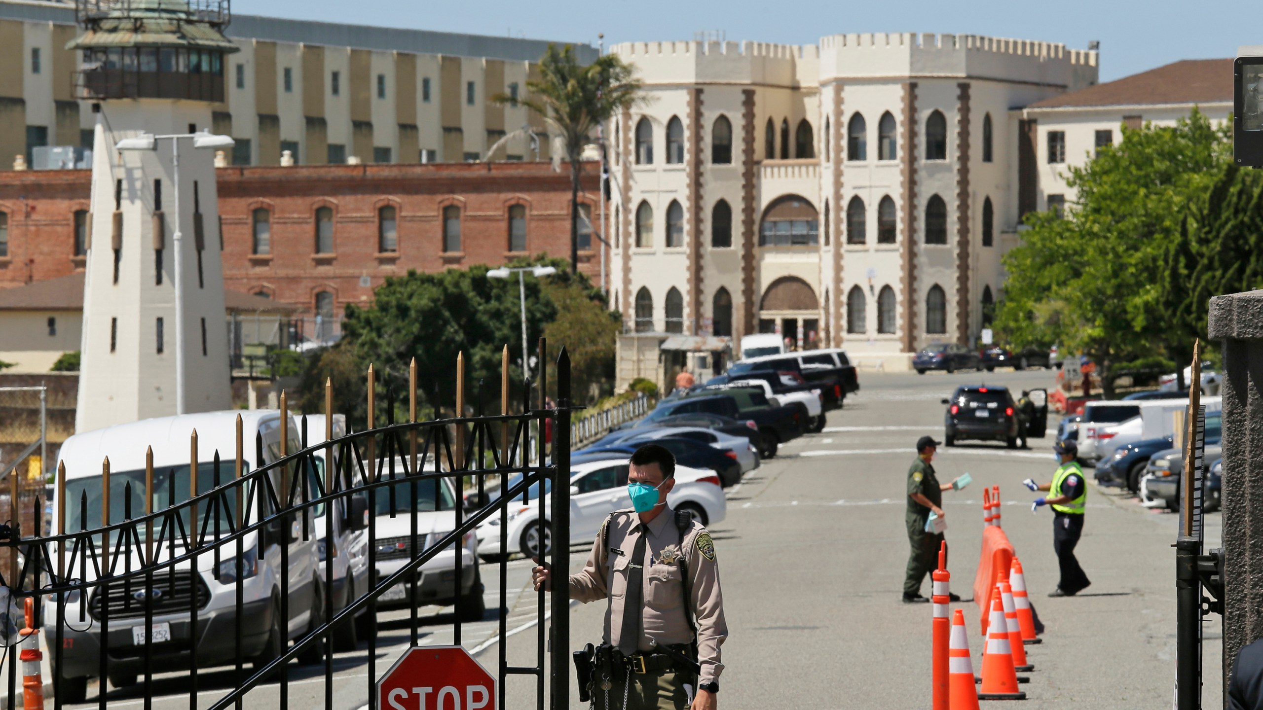 In this July 9, 2020, file photo, a correctional officer closes the main gate at San Quentin State Prison in San Quentin, Calif. A judge on Wednesday, Dec. 29, 2021, temporarily halted California's plans to speed the potential prison release dates for repeat offenders with serious and violent criminal histories under the state's "three strikes" law. (AP Photo/Eric Risberg, File)