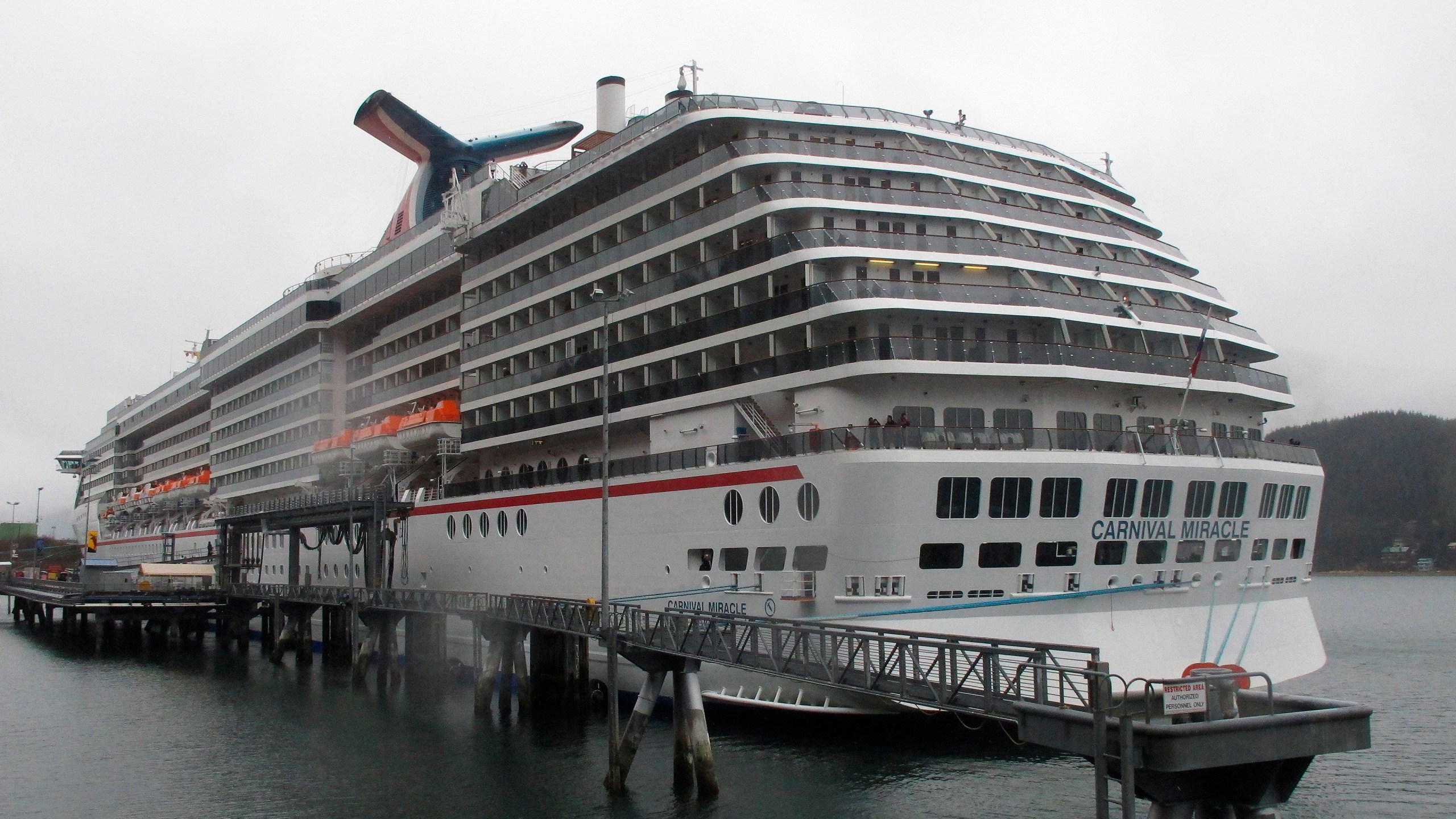 his May 2, 2013 file photo shows the Carnival Miracle docked in Juneau, Alaska. U.S. Coast Guard authorities have halted the search for a woman who reportedly went overboard on the cruise ship near Ensenada, Mexico. Petty Officer First Class Adam Stanton says authorities searched more than 31 hours for the woman before pausing the search on Sunday, Dec. 12, 2021, pending additional information. (AP Photo/Becky Bohrer, File)