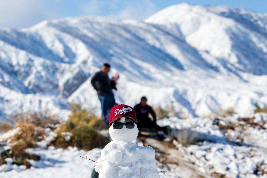 People play on the snow next to the 138 Highway around San Bernardino Forest on Nov. 29, 2019 in Phelan, California. (APU GOMES/AFP via Getty Images)