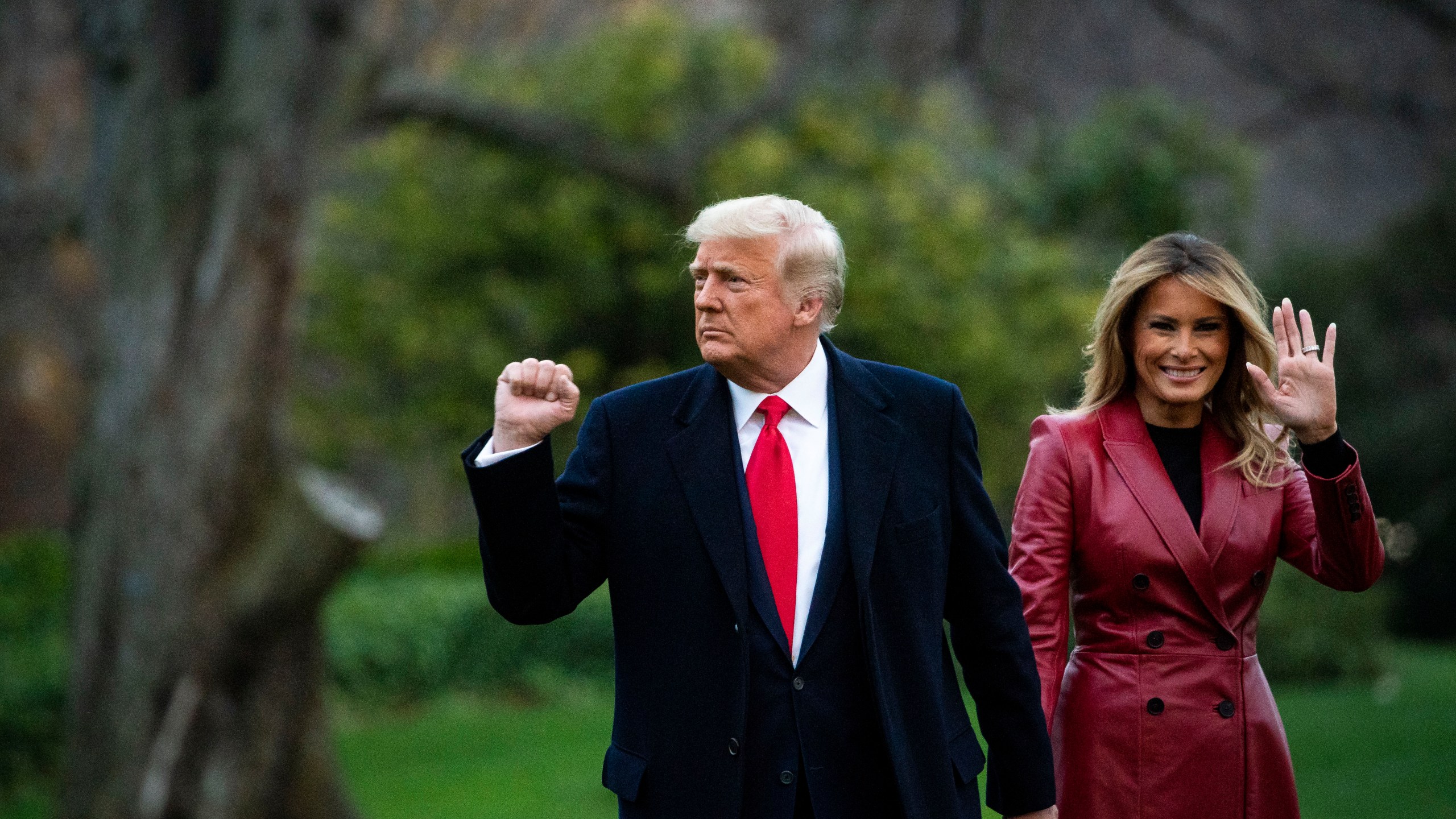 Donald Trump pumps his fist and Trump waves as they depart on the South Lawn of the White House, on December 5, 2020 in Washington, DC. (Al Drago/Getty Images)