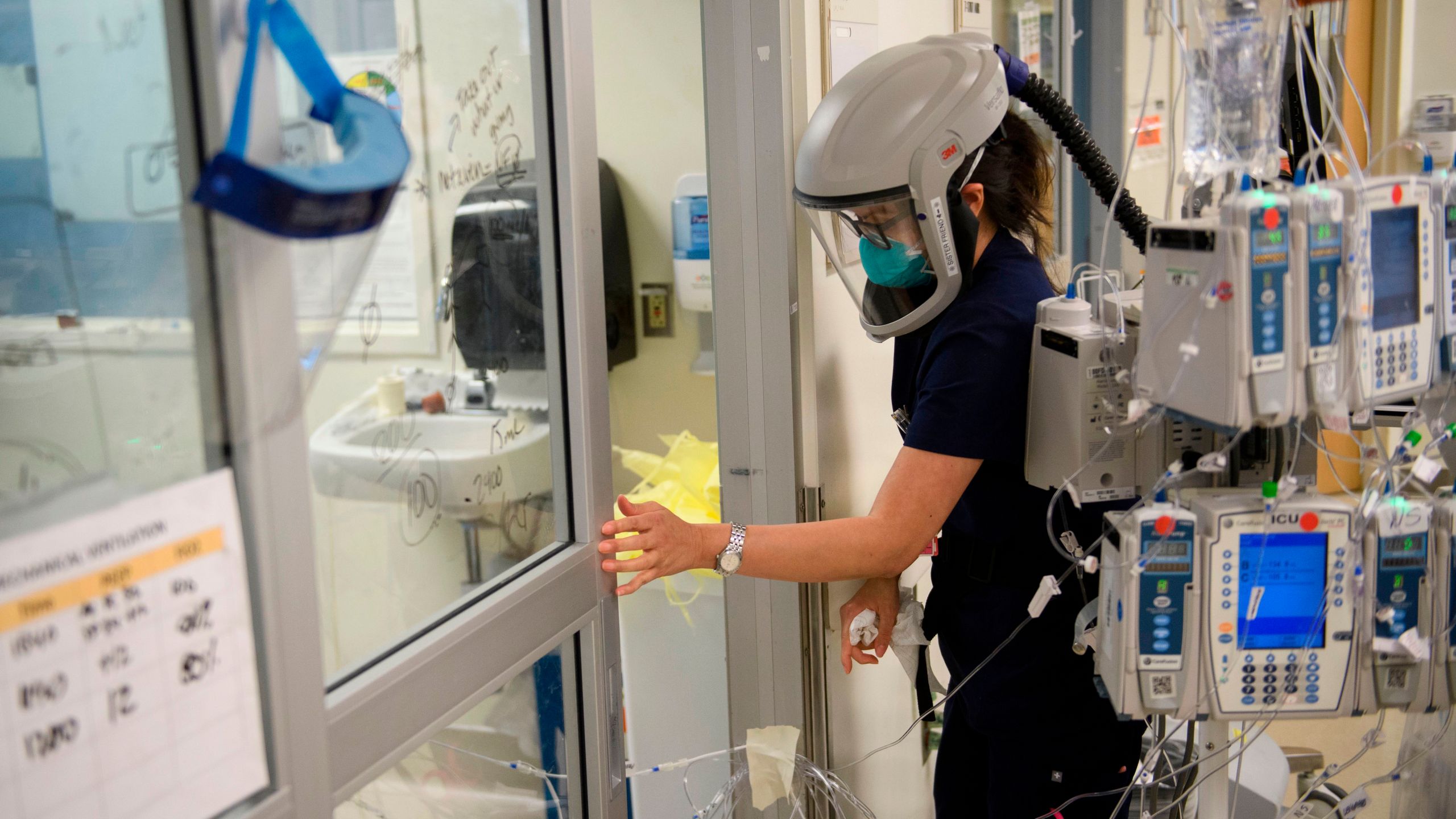 This file photo shows a nurse closing a door to a patient's room in a COVID-19 intensive care unit at Martin Luther King Jr. Community Hospital on Jan. 6, 2021 in the Willowbrook neighborhood of Los Angeles. (PATRICK T. FALLON/AFP via Getty Images)