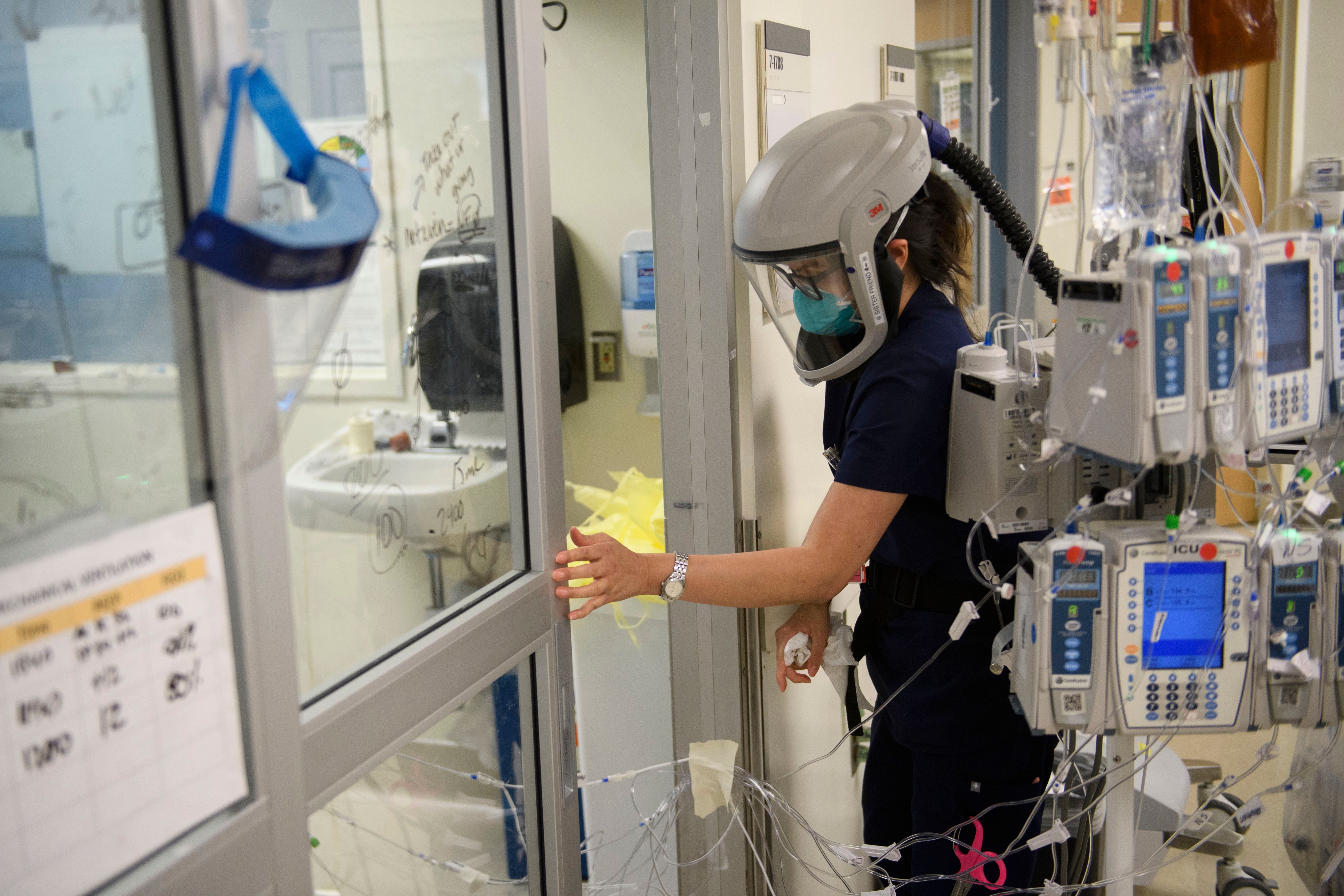 This file photo shows a nurse closing a door to a patient's room in a COVID-19 intensive care unit at Martin Luther King Jr. Community Hospital on Jan. 6, 2021 in the Willowbrook neighborhood of Los Angeles. (PATRICK T. FALLON/AFP via Getty Images)