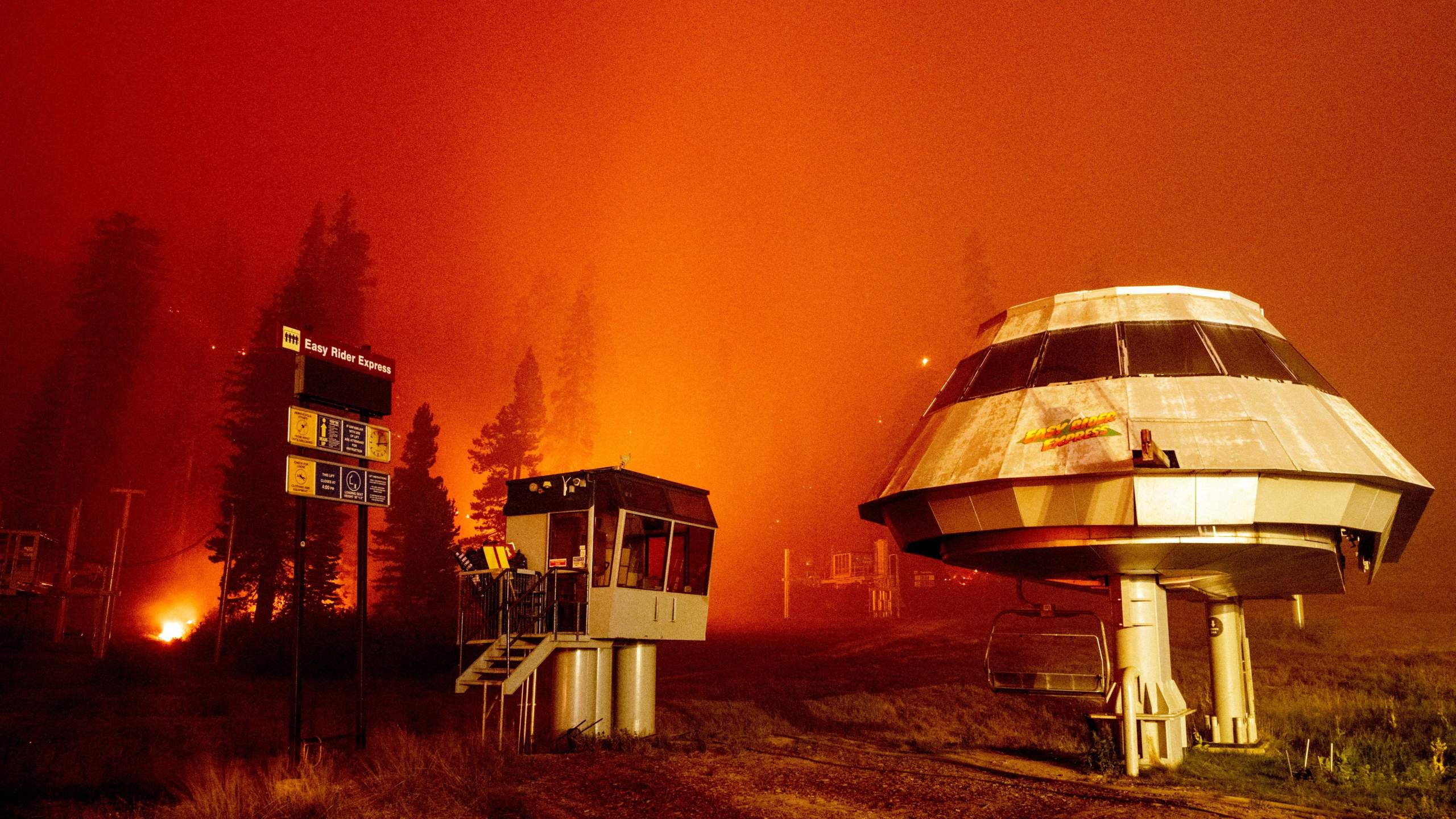 Flames surround a chair lift at Sierra-at-Tahoe Resort, a skiing area, during the Caldor fire in Twin Bridges, California on August 30, 2021. (Photo by JOSH EDELSON / AFP) (Photo by JOSH EDELSON/AFP via Getty Images)