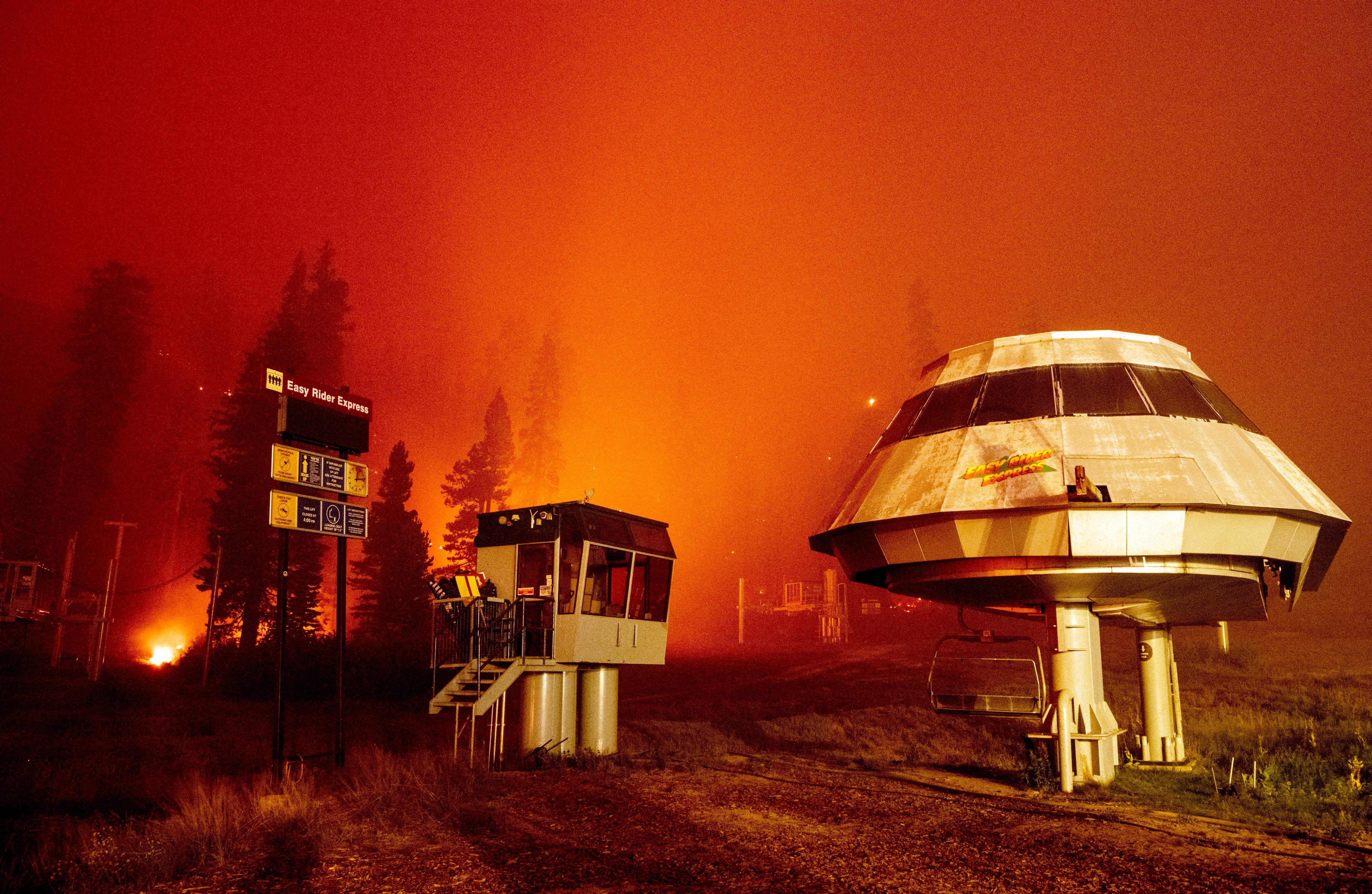 Flames surround a chair lift at Sierra-at-Tahoe Resort, a skiing area, during the Caldor fire in Twin Bridges, California on August 30, 2021. (Photo by JOSH EDELSON / AFP) (Photo by JOSH EDELSON/AFP via Getty Images)