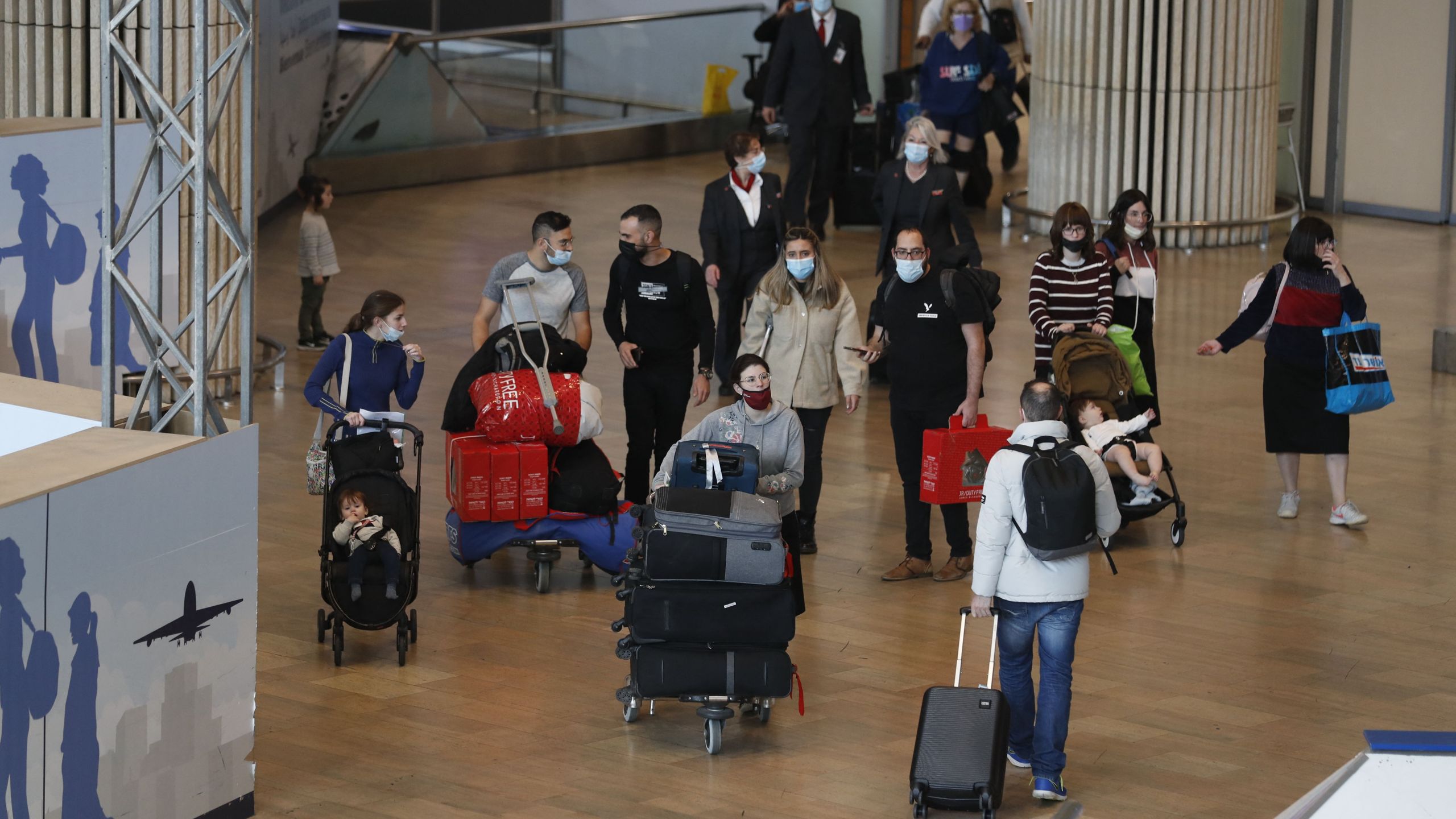 Passengers arrive to Israel's Ben Gurion Airport in Lod, east of Tel Aviv, on Nov. 28, 2021. (AHMAD GHARABLI/AFP via Getty Images)