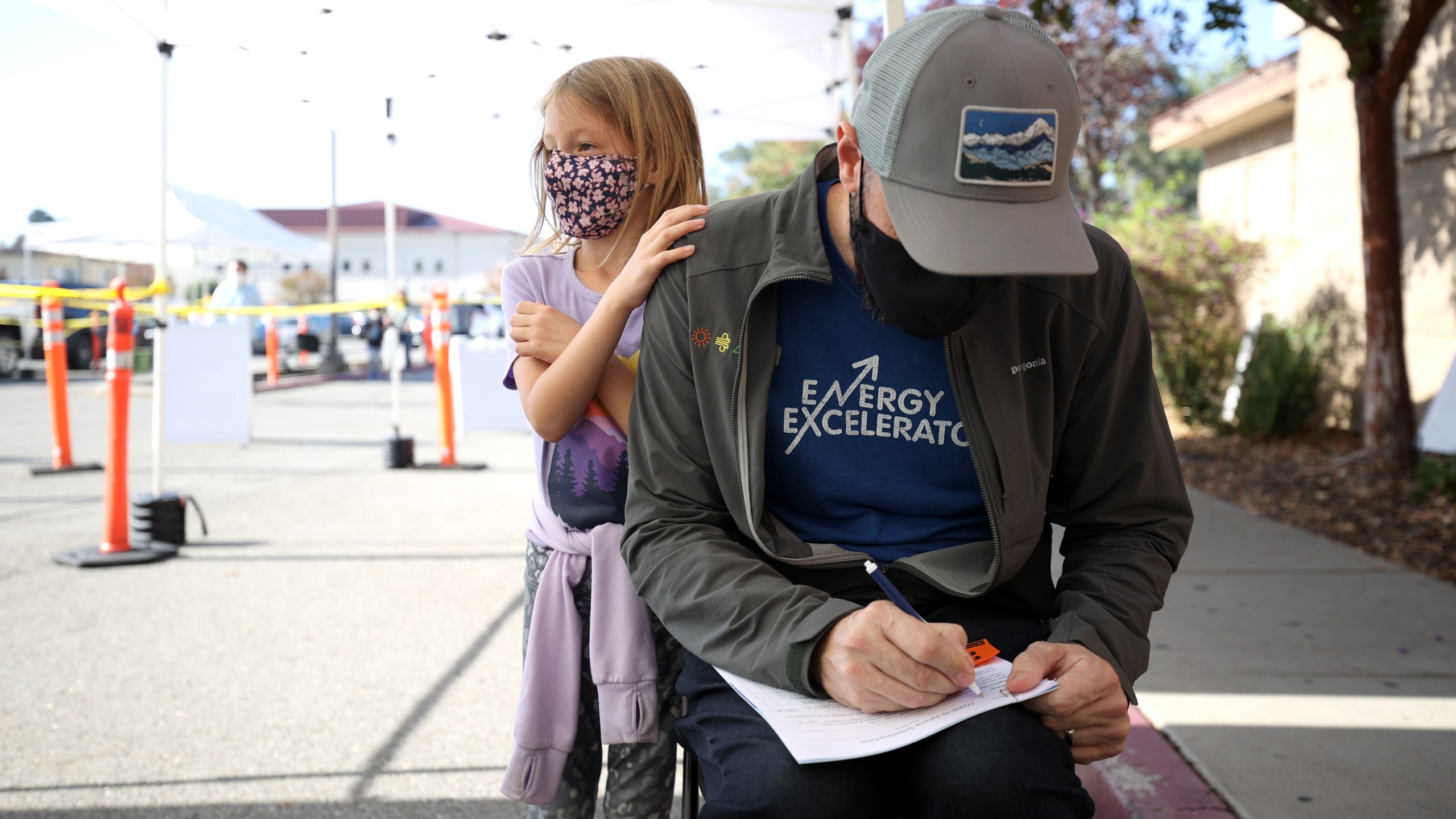 Lilah Chipman looks on as her father Ian Chipman fills out paperwork during a vaccination clinic at Emmanuel Baptist Church on Nov. 3, 2021 in San Jose. (Justin Sullivan/Getty Images)