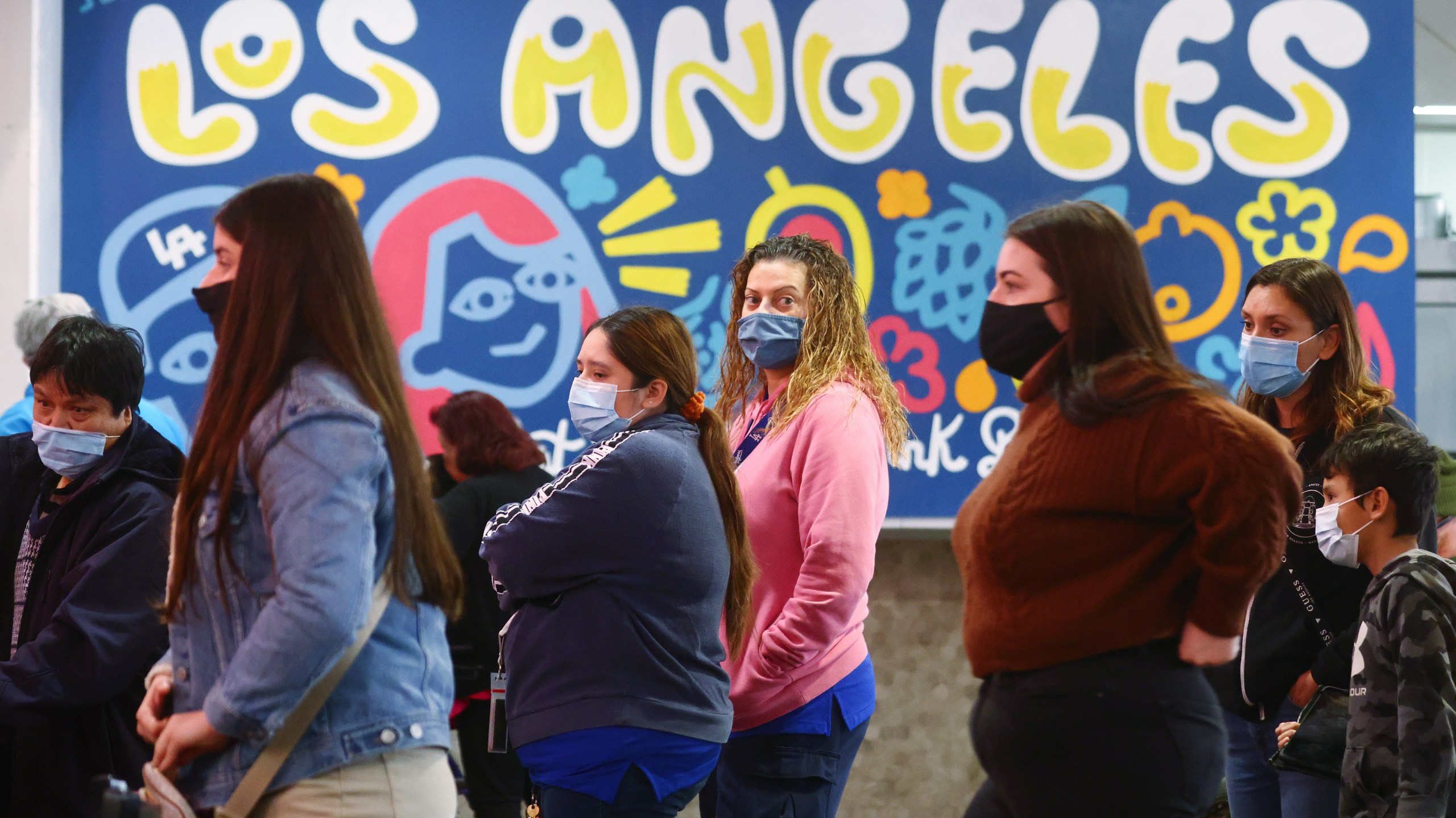 People wear face coverings inside Grand Central Market on Dec. 15, 2021 in Los Angeles, California. (Mario Tama/Getty Images)