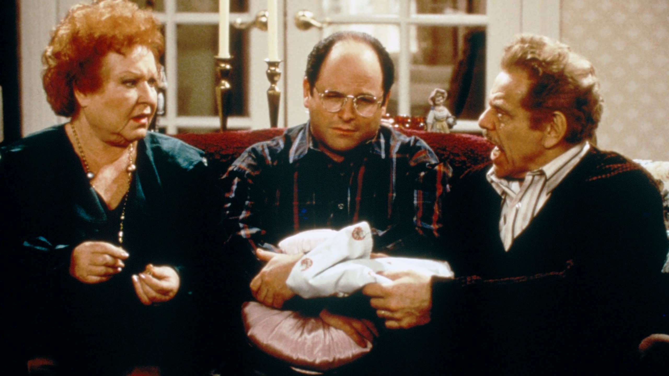 SEINFELD -- "The Shower Head" Episode 15 -- Pictured: (l-r) Estelle Harris as Estelle Costanza, Jason Alexander as George Costanza, Jerry Stiller as Frank Costanza (Photo by Margaret Norton/NBCU Photo Bank/NBCUniversal via Getty Images via Getty Images)