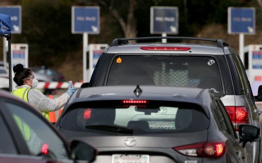 People seeking coronavirus tests line up at a Curative site in the parking lot of Dodger Stadium.(Luis Sinco/Los Angeles Times)