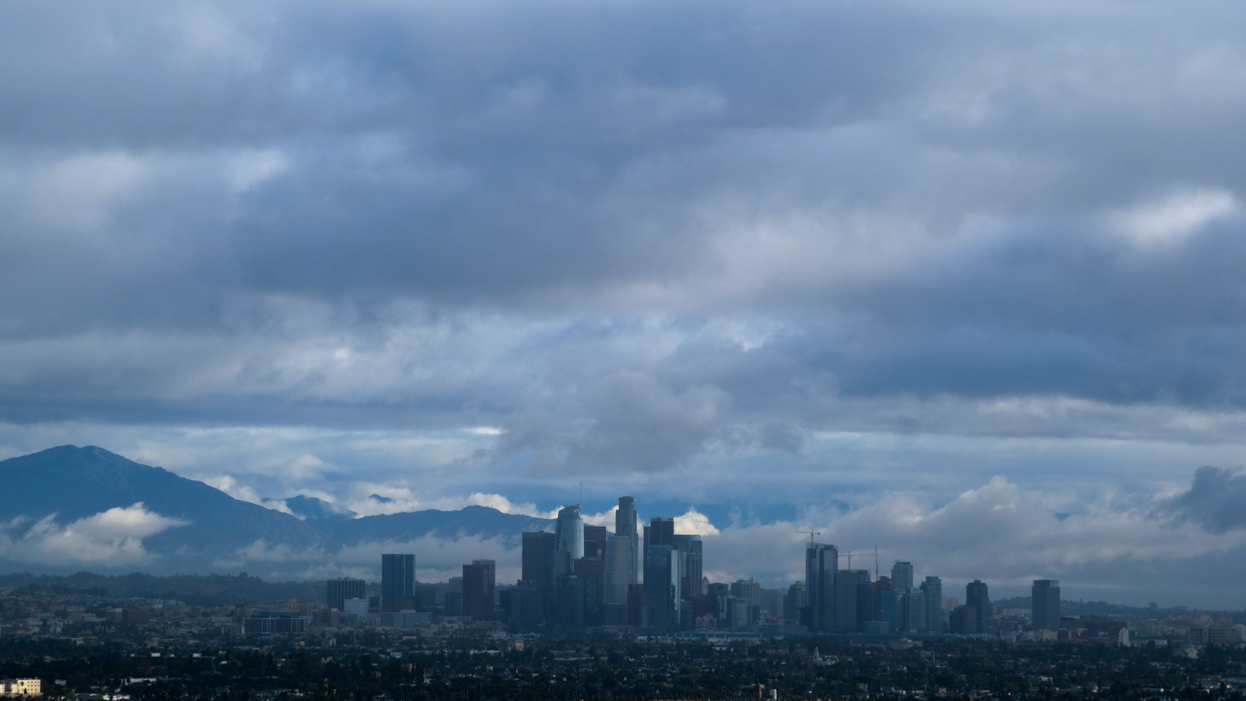 Storm clouds blanket the Los Angeles skyline is seen from Kenneth Hahn State Recreation Area on Dec. 24, 2021. (Ringo H.W. Chiu/Associated Press)