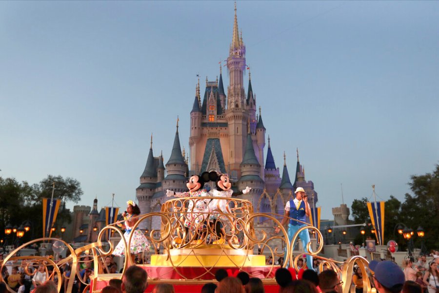 Mickey and Minnie Mouse perform during a parade as they pass by the Cinderella Castle at the Magic Kingdom theme park at Walt Disney World in Lake Buena Vista, Fla. Wednesday, Jan. 15, 2020. (AP Photo/John Raoux, File)