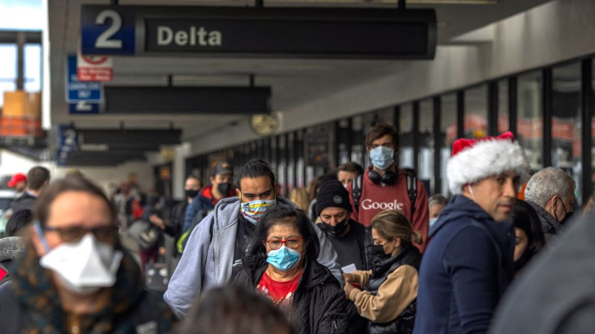 Travelers arrive at Los Angeles International Airport in Los Angeles, California, on December 24, 2021. (DAVID MCNEW/AFP via Getty Images)