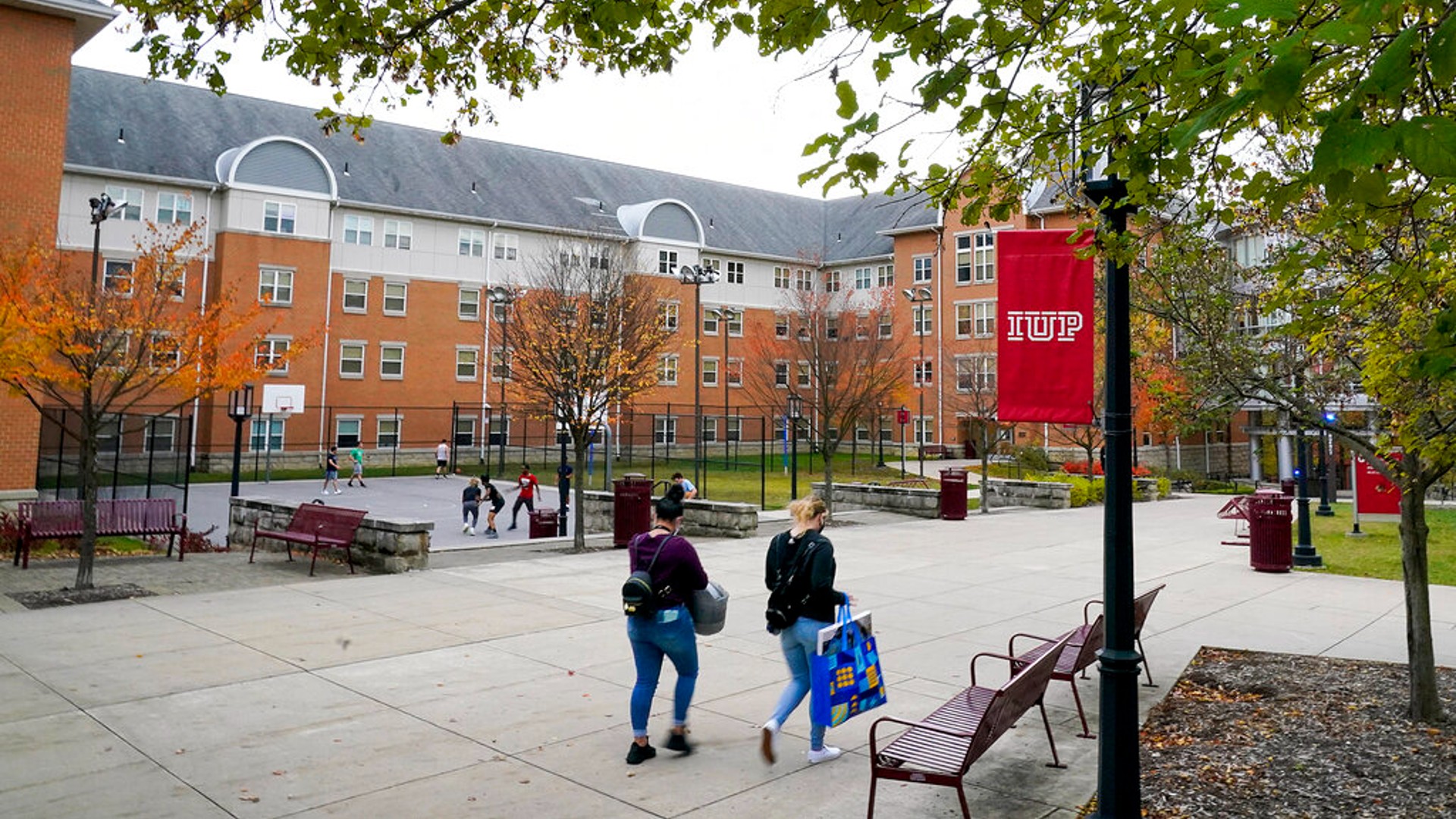 Students walk on the campus of Indiana University of Pennsylvania in Indiana, Pa., Oct. 21, 2020. (AP Photo/Gene J. Puskar, File)