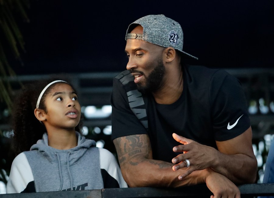 In this July 26, 2018, file photo, former Los Angeles Laker Kobe Bryant and his daughter Gianna watch the U.S. national championships swimming meet in Irvine, Calif. (AP Photo/Chris Carlson, file)