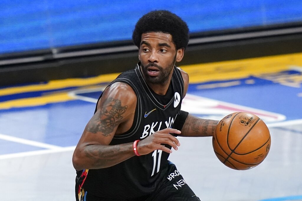 Brooklyn Nets' Kyrie Irving moves the ball during the first half of an NBA basketball game against the Cleveland Cavaliers Sunday, May 16, 2021, in New York. (AP Photo/Frank Franklin II, File)