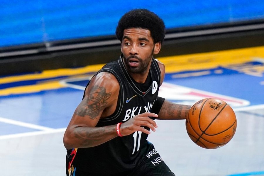 Brooklyn Nets' Kyrie Irving moves the ball during the first half of an NBA basketball game against the Cleveland Cavaliers Sunday, May 16, 2021, in New York. (AP Photo/Frank Franklin II, File)