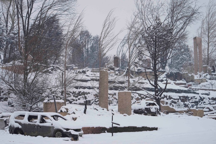 Snow covers the burned remains of homes in Louisville, Colo., on Jan. 1, 2022, after the Marshall Wildfire. (Jack Dempsey/Associated Press)