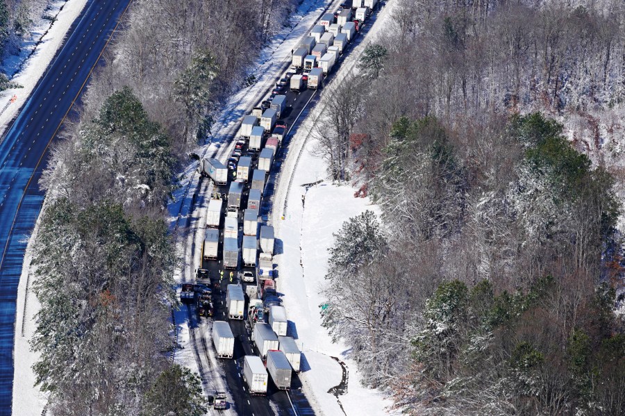 Drivers wait for the traffic to be cleared as cars and trucks are stranded on sections of Interstate 95 on Jan. 4, 2022, in Carmel Church, Va. Close to 48 miles of the Interstate was closed due to ice and snow. (AP Photo/Steve Helber)