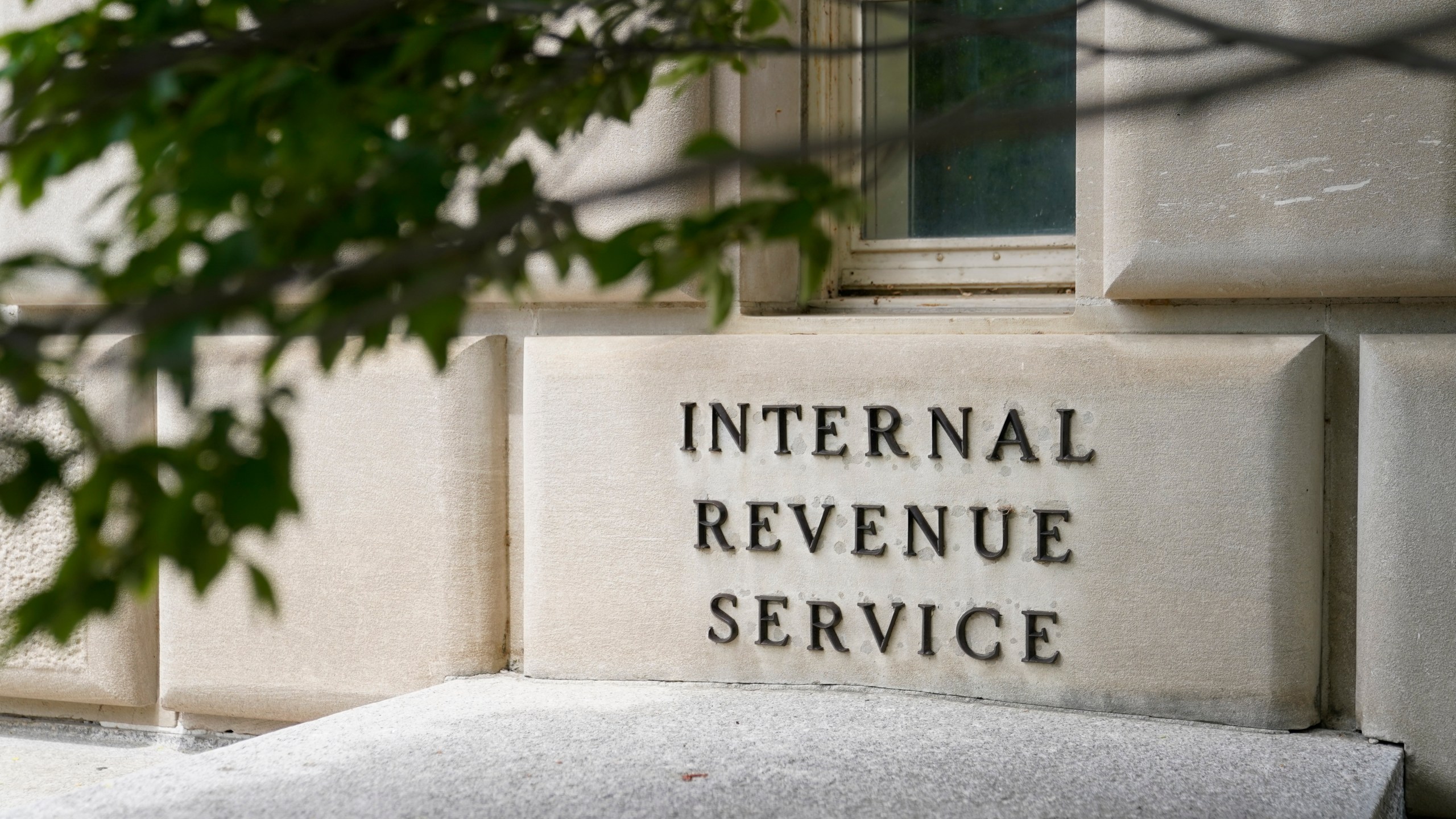 This May 4, 2021 photo shows a sign outside the Internal Revenue Service building in Washington. This year's tax filing season will begin on Jan. 24, 17 days earlier than last year, the Internal Revenue Service announced Monday, Jan. 10, 2022. (AP Photo/Patrick Semansky)