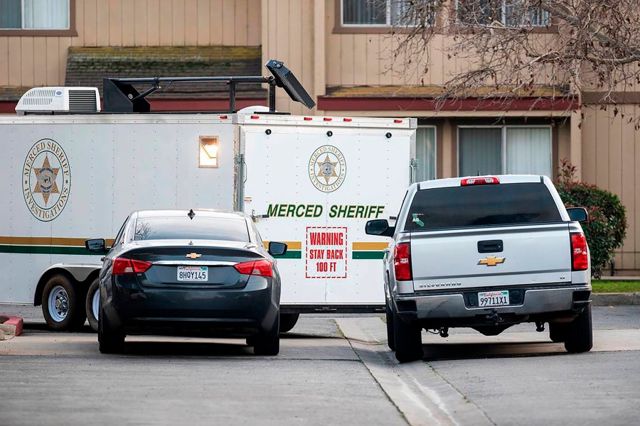 The Merced County Sheriff's Office investigate after three children were found dead inside a residence at an apartment complex in Le Grand, Calif., on Wednesday, Jan. 12, 2022. The mother of three children found dead inside a central California home has been charged with murder, officials said Thursday. (Andrew Kuhn/The Merced Sun-Star via AP)