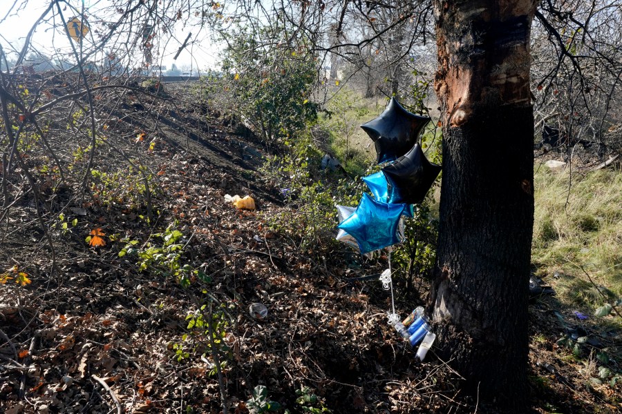 A small memorial marks the scene, Wednesday, Jan. 19, 2022, were the body of a woman was found inside a car that had crashed off Interstate 80 in Sacramento, Calif. A caller to the California Highway Patrol on Tuesday, Jan. 18, reported seeing a vehicle in a ditch just off the onramp to westbound I-80 from West El Camino Ave. Woodland police confirmed the woman found in the car was the same woman reported missing to them on Monday. (AP Photo/Rich Pedroncelli)