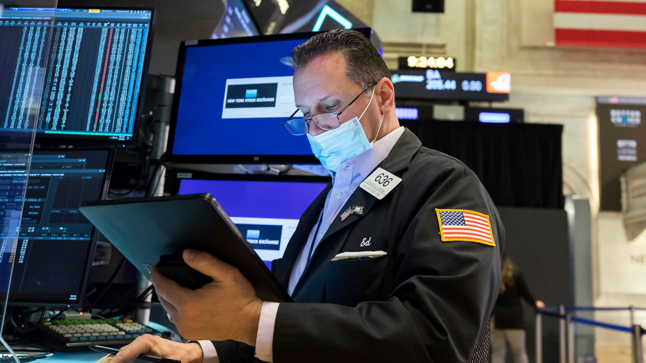 In this photo provided by the New York Stock Exchange, trader Edward Curran works on the floor, Monday, Jan. 24, 2022. The Dow Jones Industrial Average dropped more than 1,000 points Monday as financial markets buckled in anticipation of inflation-fighting measures from the Federal Reserve and fretted over the possibility of conflict between Russia and Ukraine. (Courtney Crow/New York Stock Exchange via AP)