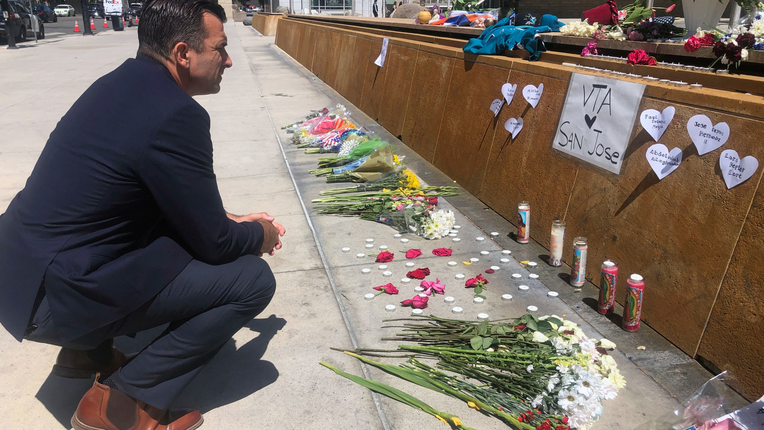 San Jose Mayor Sam Liccardo stops to view a makeshift memorial for the rail yard shooting victims in front of City Hall in San Jose on May 27, 2021. (Haven Daley/Associated Press)