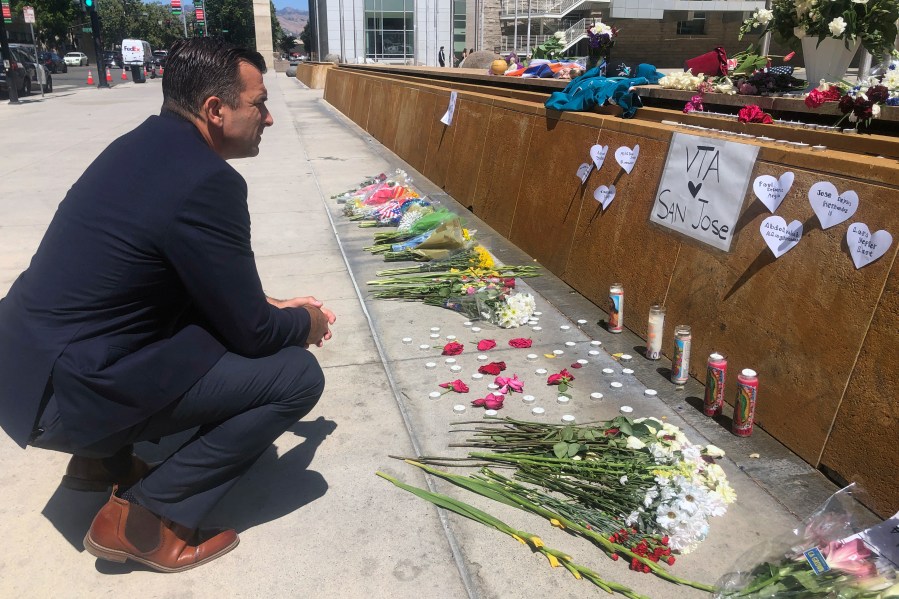 San Jose Mayor Sam Liccardo stops to view a makeshift memorial for the rail yard shooting victims in front of City Hall in San Jose on May 27, 2021. (Haven Daley/Associated Press)