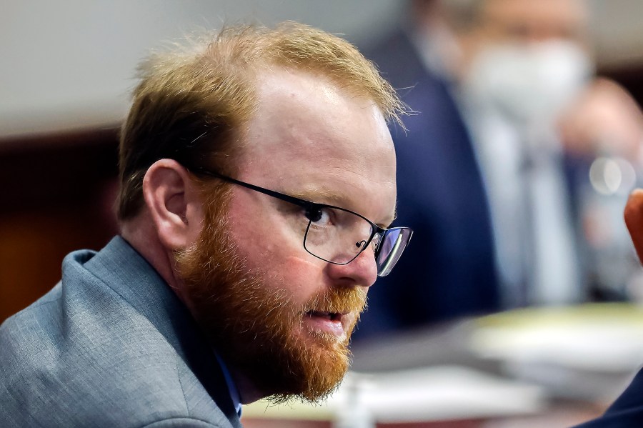 Travis McMichael is shown during the sentencing of he and his father Greg McMichael and neighbor, William "Roddie" Bryan in the Glynn County Courthouse, Friday, Jan. 7, 2022, in Brunswick, Ga. The man who fatally shot Ahmaud Arbery and his father have reached a plea deal that could avoid their trial on federal hate crime charges. Arbery's parents denounced the deal as a betrayal, and called on the judge to reject it. Court documents filed late Sunday, Jan. 30, 2022, by prosecutors for the U.S. Justice Department say plea agreements were reached with Travis and Greg McMichael. (AP Photo/Stephen B. Morton, Pool, File)