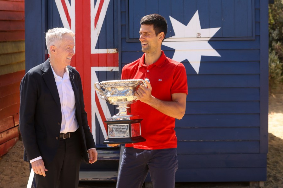 Serbia's Novak Djokovic, right, stands with Australian Open tournament director Craig Tiley for a trophy photo shoot following his win the Australian Open tennis championships in Melbourne, Australia, Monday, Feb 22, 2021. The No. 1-ranked Djokovic was denied entry at the Melbourne airport late Wednesday, Jan 5, 2022, after border officials canceled his visa for failing to meet its entry requirement that all non-citizens be fully vaccinated for COVID-19. (AP Photo/Hamish Blair)