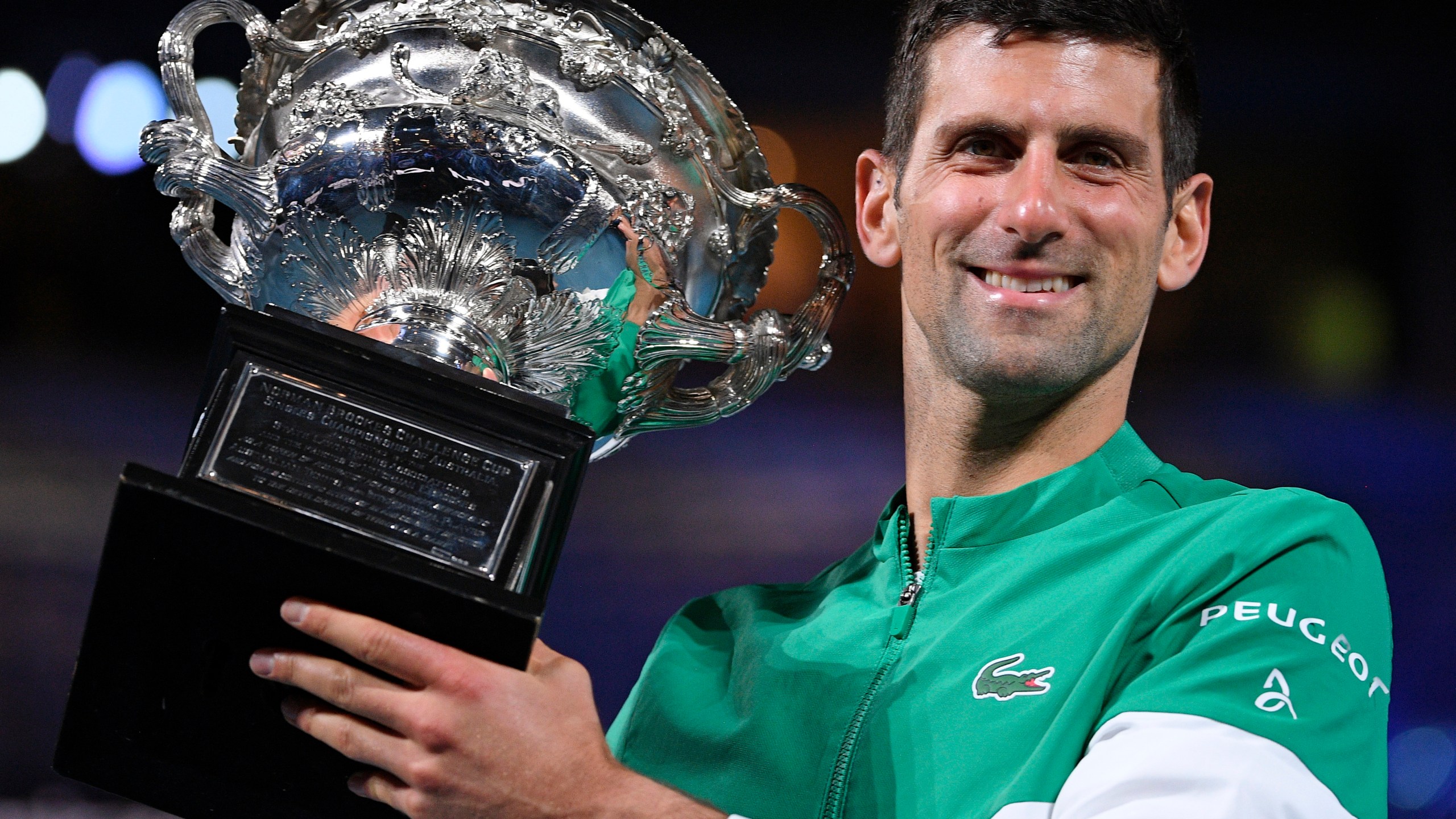 Serbia's Novak Djokovic holds the Norman Brookes Challenge Cup after defeating Russia's Daniil Medvedev in the men's singles final at the Australian Open tennis championship in Melbourne, Australia, Sunday, Feb. 21, 2021. Djokovic has had his visa canceled and been denied entry to Australia, Thursday, Jan. 6, 2022 and is set to be removed from the country after spending the night at the Melbourne airport as officials refused to let him enter the country for the Australian Open after an apparent visa mix-up.(AP Photo/Andy Brownbill, File)