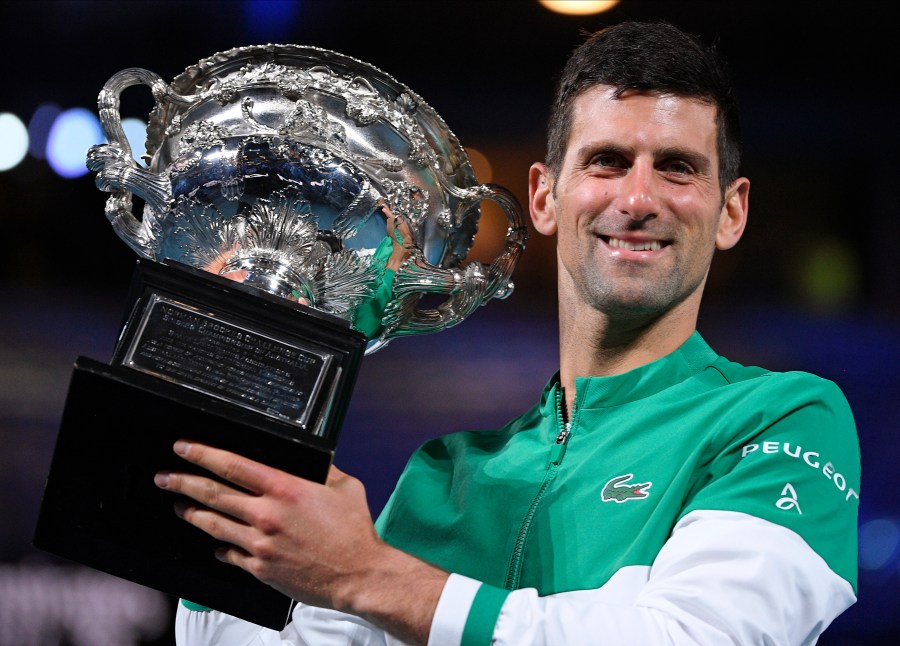 Serbia's Novak Djokovic holds the Norman Brookes Challenge Cup after defeating Russia's Daniil Medvedev in the men's singles final at the Australian Open tennis championship in Melbourne, Australia, Sunday, Feb. 21, 2021. Djokovic has had his visa canceled and been denied entry to Australia, Thursday, Jan. 6, 2022 and is set to be removed from the country after spending the night at the Melbourne airport as officials refused to let him enter the country for the Australian Open after an apparent visa mix-up.(AP Photo/Andy Brownbill, File)