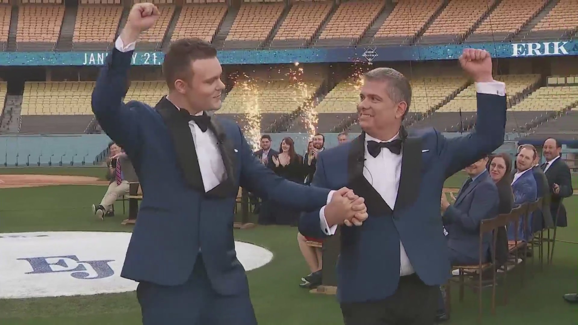 Software engineer and model Jonathan Cottrell, left, and Dodgers executive Erik Braverman tied the knot on the Dodger Stadium pitcher's mound on Jan. 21, 2022. (KTLA)