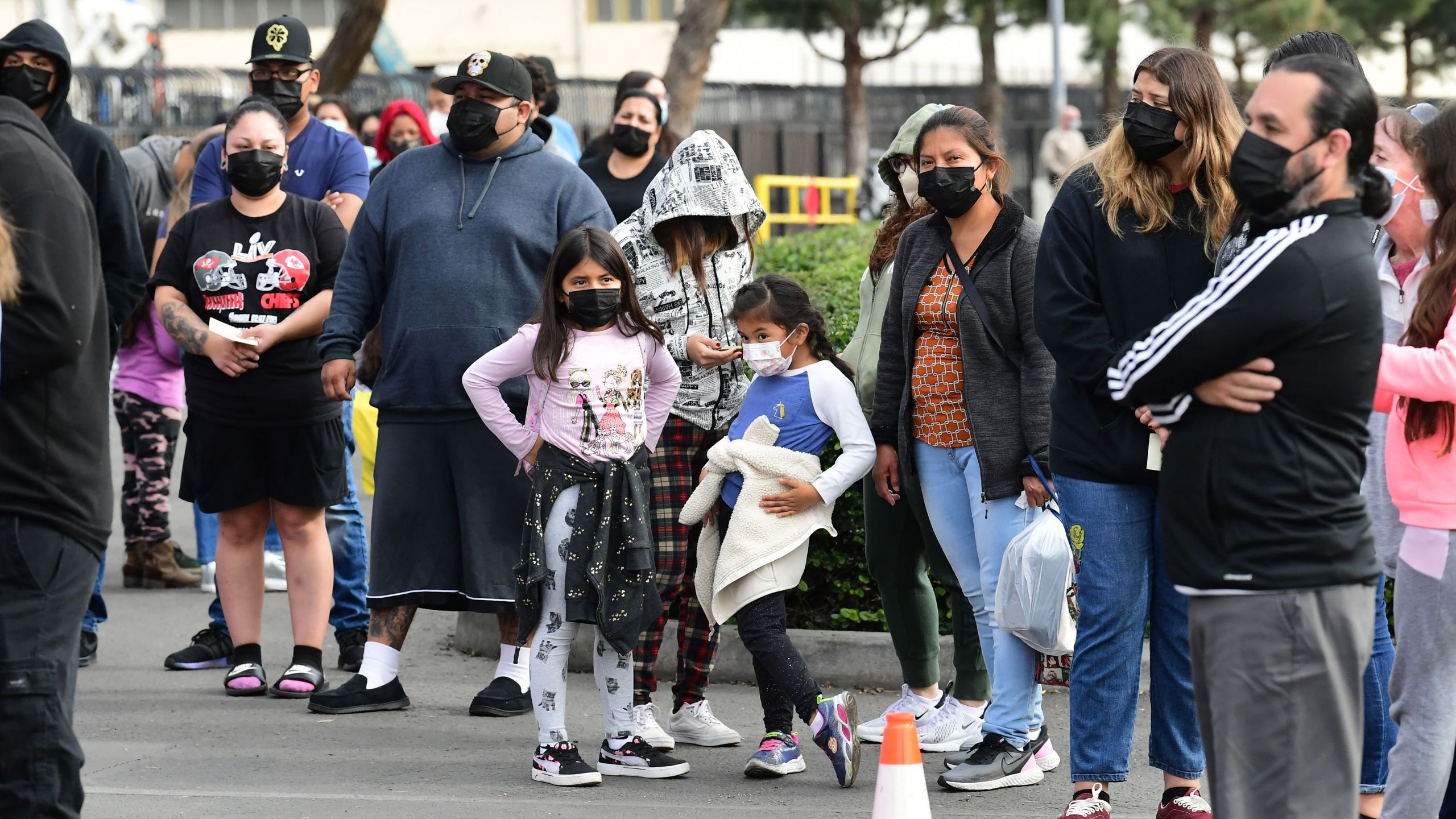 People wait in line for a test at a BusTest Express mobile COVID-19 test site in Paramount, a city in Los Angeles County, California, on Jan. 12, 2022. (FREDERIC J. BROWN/AFP via Getty Images)