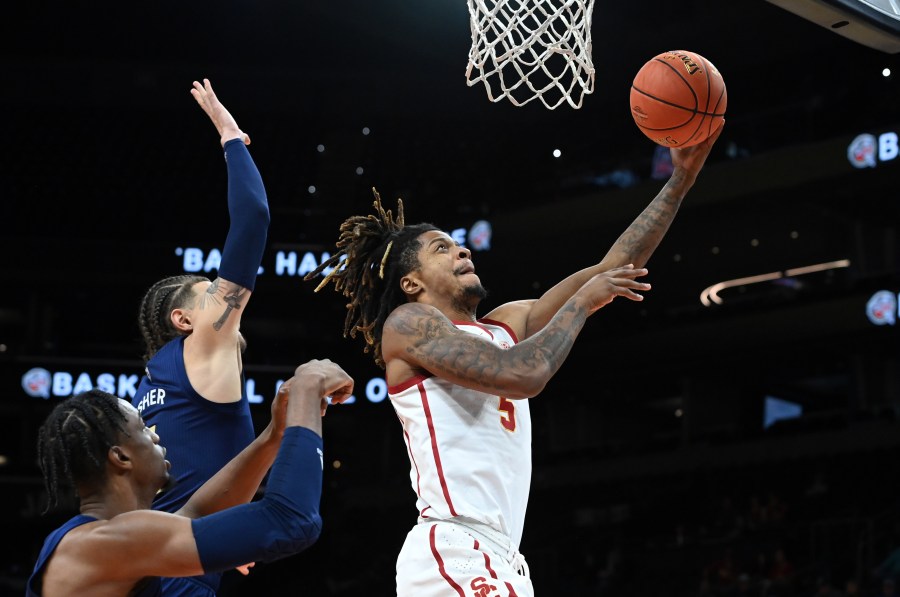 Isaiah White #5 of the University of Southern California Trojans scores on a lay up while being defended by Jordan Usher #4 of the Georgia Tech Yellow Jackets during the second half at the Jerry Colangelo Classic at Footprint Center on Dec. 18, 2021 in Phoenix. (Norm Hall/Getty Images)