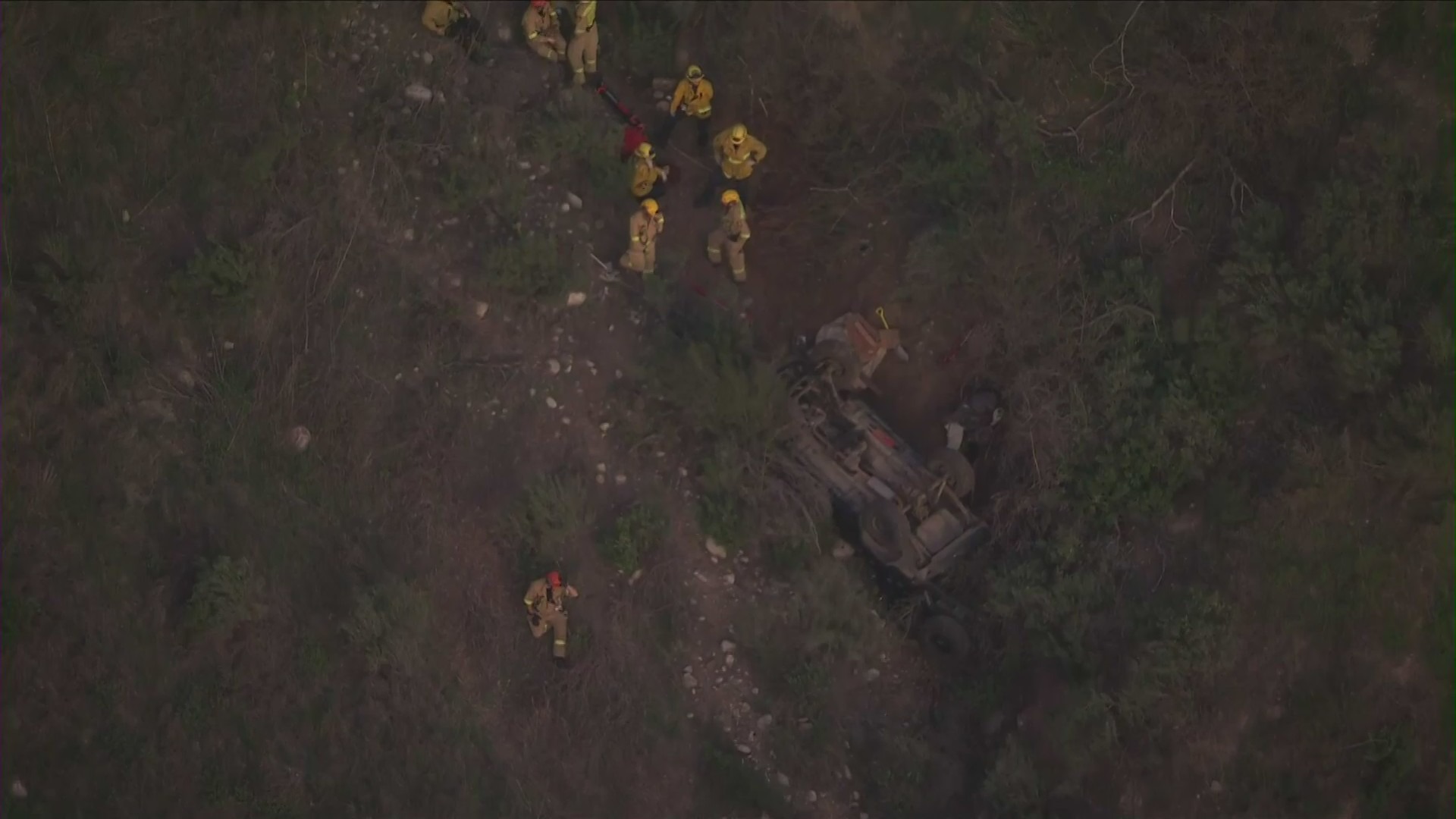 A man is dead after a car rolled down a rugged hillside in Sunland on Jan. 30, 2022. (KTLA)