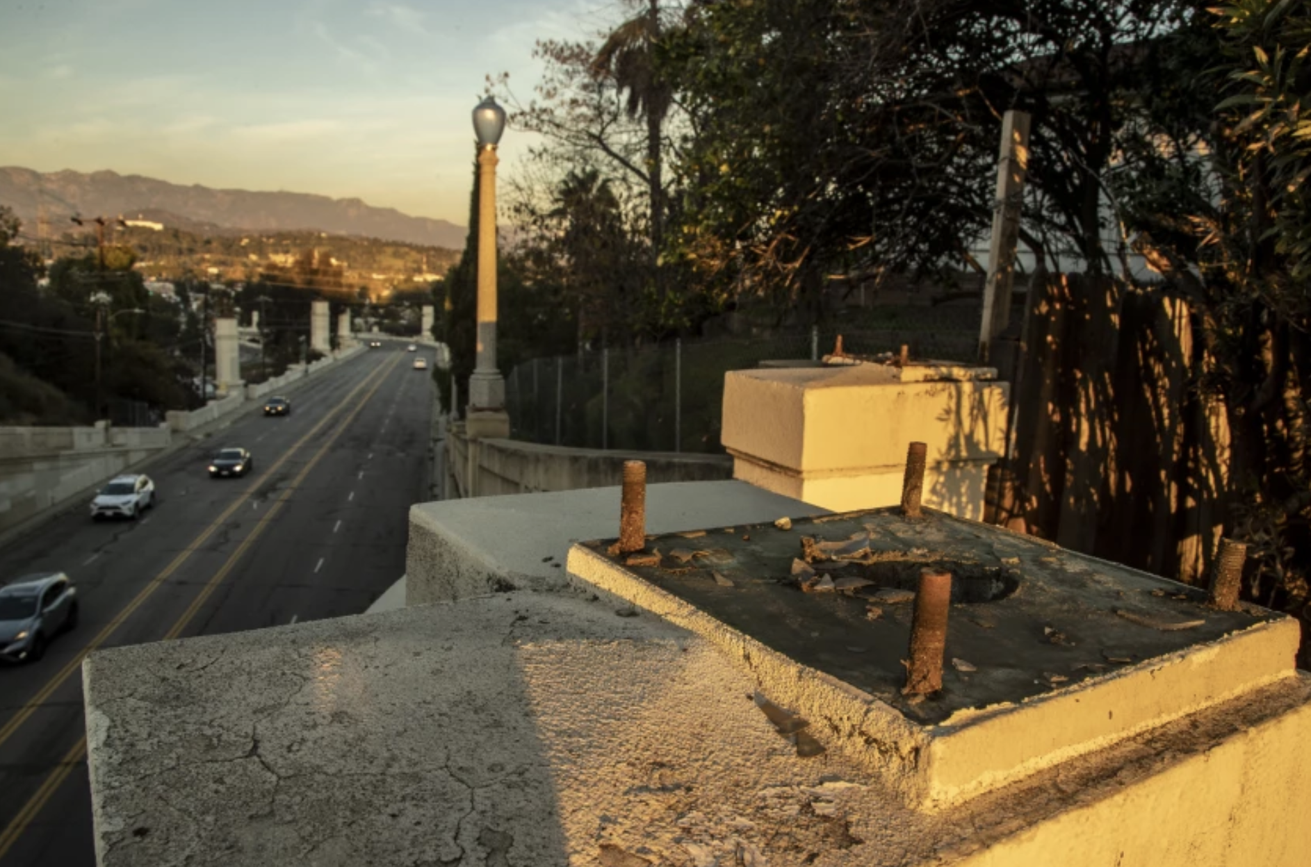 Large bolts remain where a bronze streetlight once stood on the Glendale-Hyperion Viaduct on Monday. Twenty-two lights have been stolen, and the L.A. Bureau of Street Lighting has removed an additional 18 lights for safeguarding.(Brian van der Brug / Los Angeles Times)