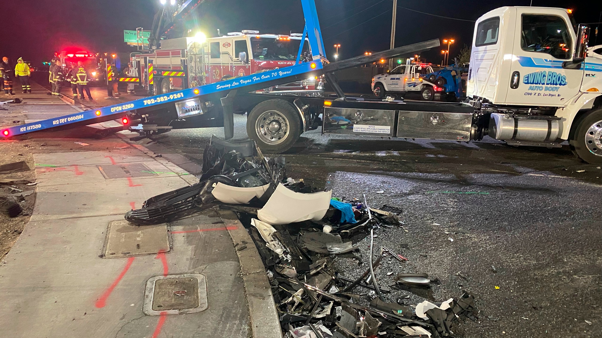 Authorities get set to tow a vehicle involved a six-car crash at the scene of a fatal crash on West Cheyenne Avenue in North Las Vegas, Sunday, Jan. 30, 2022. Police in North Las Vegas say the nine people killed in a horrific six-vehicle weekend crash ranged in age from their 50s to just 5 years old. (David Wilson/Las Vegas Review-Journal via AP)