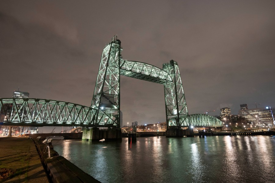 View of the Koningshaven Bridge, known as De Hef, (The Lift), in Rotterdam, Netherlands, Thursday, Feb. 3, 2022. A plan to dismantle the historic bridge in the heart of Dutch port city so that a huge yacht, reportedly being built for Amazon founder Jeff Bezos, can get to the North Sea is unlikely to be plain sailing. Reports this week that the city had already agreed to take apart the recently restored bridge sparked anger in the city, with one Facebook group set up calling for people to pelt the multimillion dollar yacht with rotten eggs. (AP Photo/Peter Dejong)