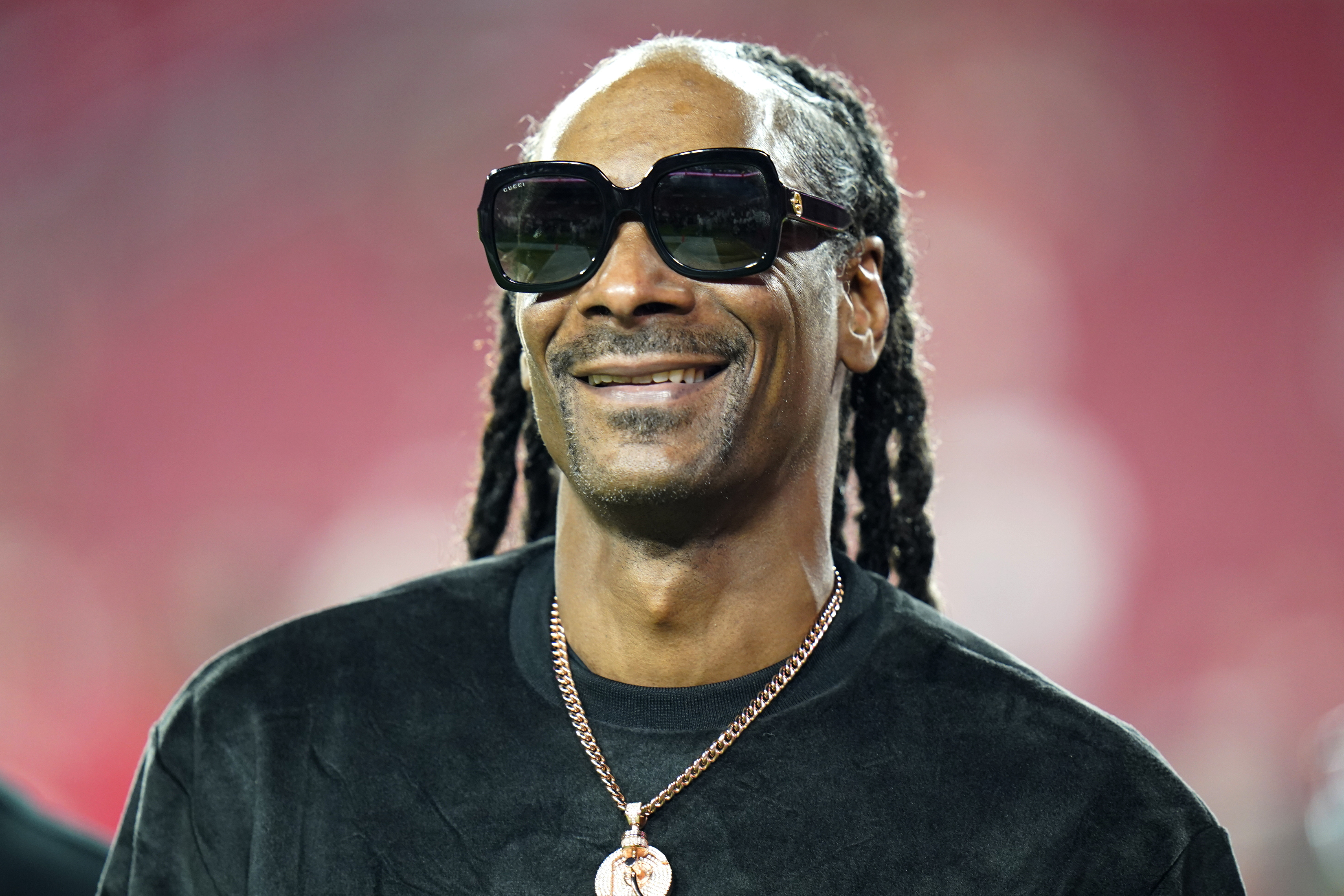 Entertainer Snoop Dogg walks on the field before an NFL football game between the Tampa Bay Buccaneers and the New Orleans Saints Sunday, Dec. 19, 2021, in Tampa, Fla. Snoop Dogg says he won’t let the big Super Bowl stage rattle his nerves. The ultra-smooth rapper said he will worry about his upcoming halftime performance after the fact. He’ll take the stage with Dr. Dre, Eminem, Kendrick Lamar and Mary J. Blige during Super Bowl 56 on Sunday, Feb. 13, 2022. (AP Photo/Chris O'Meara, File)