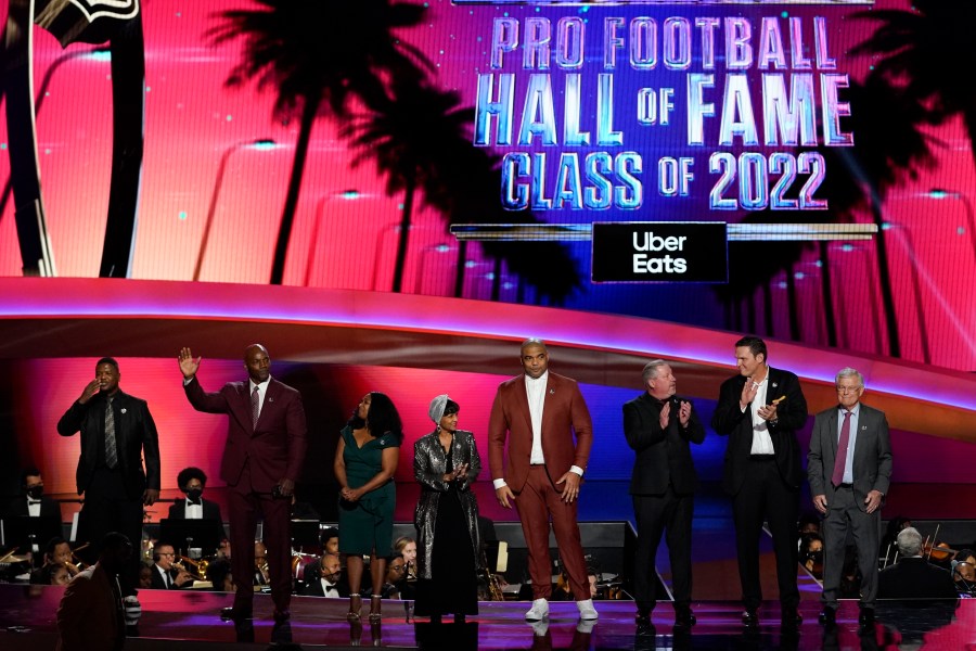 The 2022 NFL Football Hall of Fame class is seen during the NFL Honors show Thursday, Feb. 10, 2022, in Inglewood, Calif. The class is: Tony Boselli, LeRoy Butler, Sam Mills, Richard Seymour, Bryant Young, Cliff Branch, Art McNally and Dick Vermeil. Filling in for Sam Mills is Melanie Mills and filling in for Tony Boselli is Elain Anderson. (AP Photo/Mark J. Terrill)