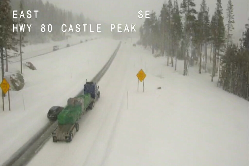 In this image taken from video from a Caltrans remote video traffic camera, light traffic makes its way in snowy conditions along Interstate 80 at Castle Peak, Calif., Tuesday, Feb. 22, 2022. A cold storm brought snow and rain to California on Tuesday and forecasters warned that freezing temperatures will follow. A winter storm warning was posted in the northern Sierra Nevada and Caltrans urged motorists to check for chain controls on major routes. (Caltrans via AP)