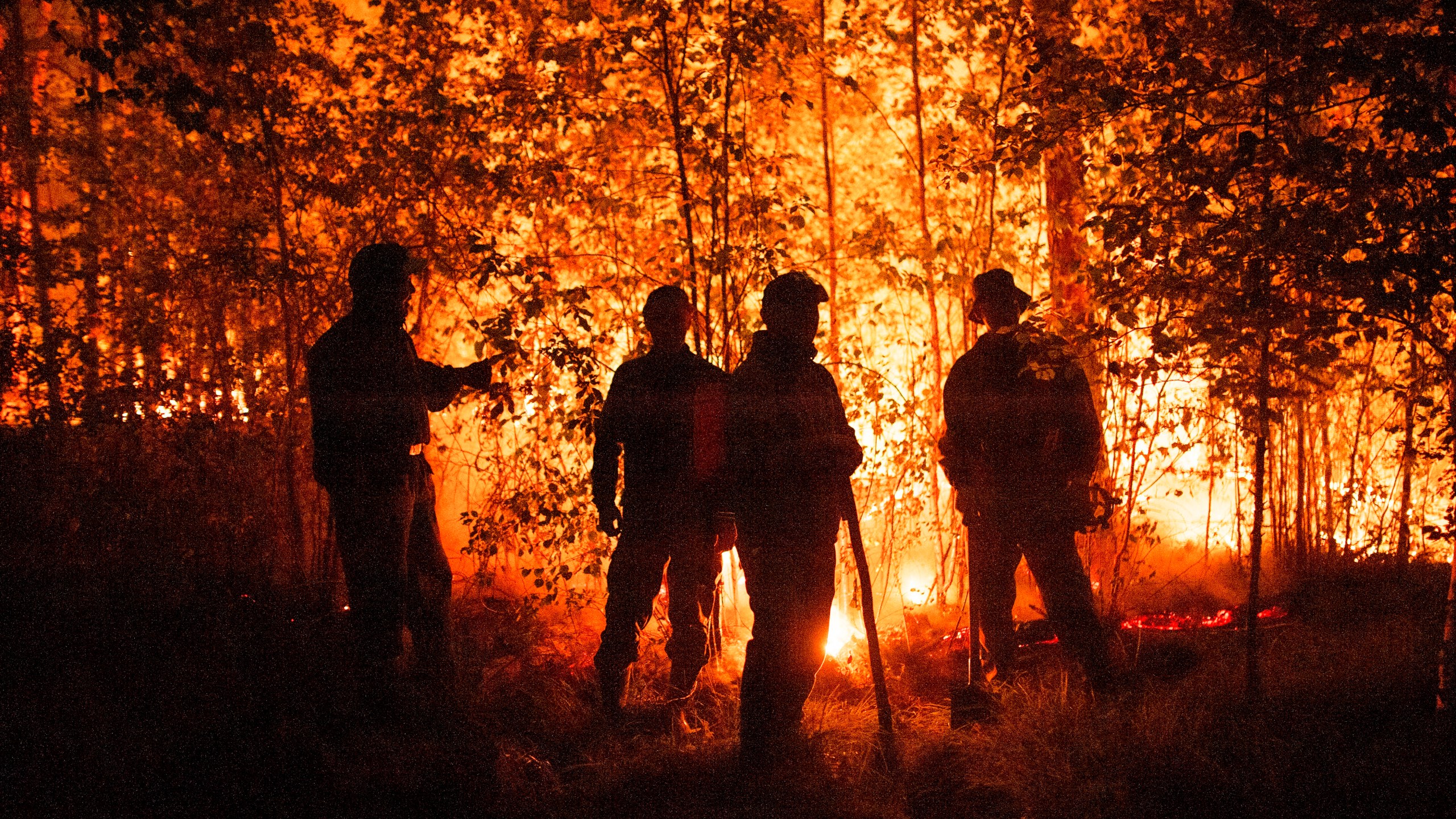 Firefighters work at the scene of forest fire near Kyuyorelyakh village at Gorny Ulus area, west of Yakutsk, in Russia Thursday, Aug. 5, 2021. A warming planet and land use changes mean more wildfires will scorch large parts of the globe in coming decades. That's according to a UN report released Wednesday, Feb. 23, 2022 that says many governments are ill-prepared to address the problem. (AP Photo/Ivan Nikiforov, File)