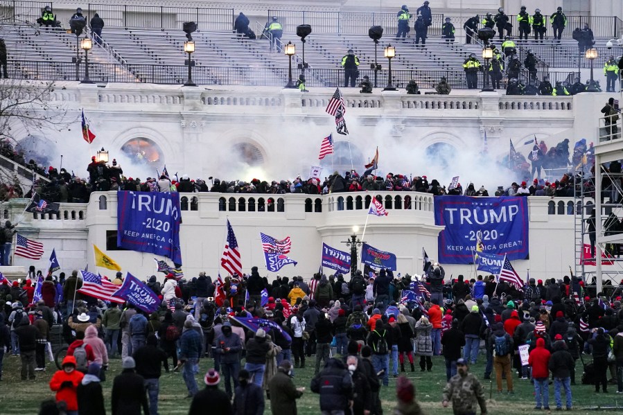 Violent insurrectionists, loyal to President Donald Trump, storm the Capitol in Washington on Jan. 6, 2021. The first trial for one of the hundreds of Capitol riot prosecutions starts this week, with jury selection scheduled to begin on Monday, Feb. 28, 2022, for the case against Guy Wesley Reffitt. (AP Photo/John Minchillo, File)