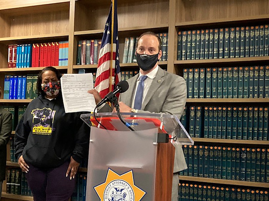 San Francisco District Attorney Chesa Boudin holds a report at a news conference in San Francisco, Tuesday, Feb. 15, 2022. Boudin's stunning assertion that police crime labs are using rape and sexual assault survivors' DNA without their consent to investigate unrelated crimes and storing the DNA indefinitely has shocked prosecutors nationwide, as sexual assault victims' groups decry the chilling effect it could have on people willing to report sexual assaults. (AP Photo/Olga R. Rodrigues)