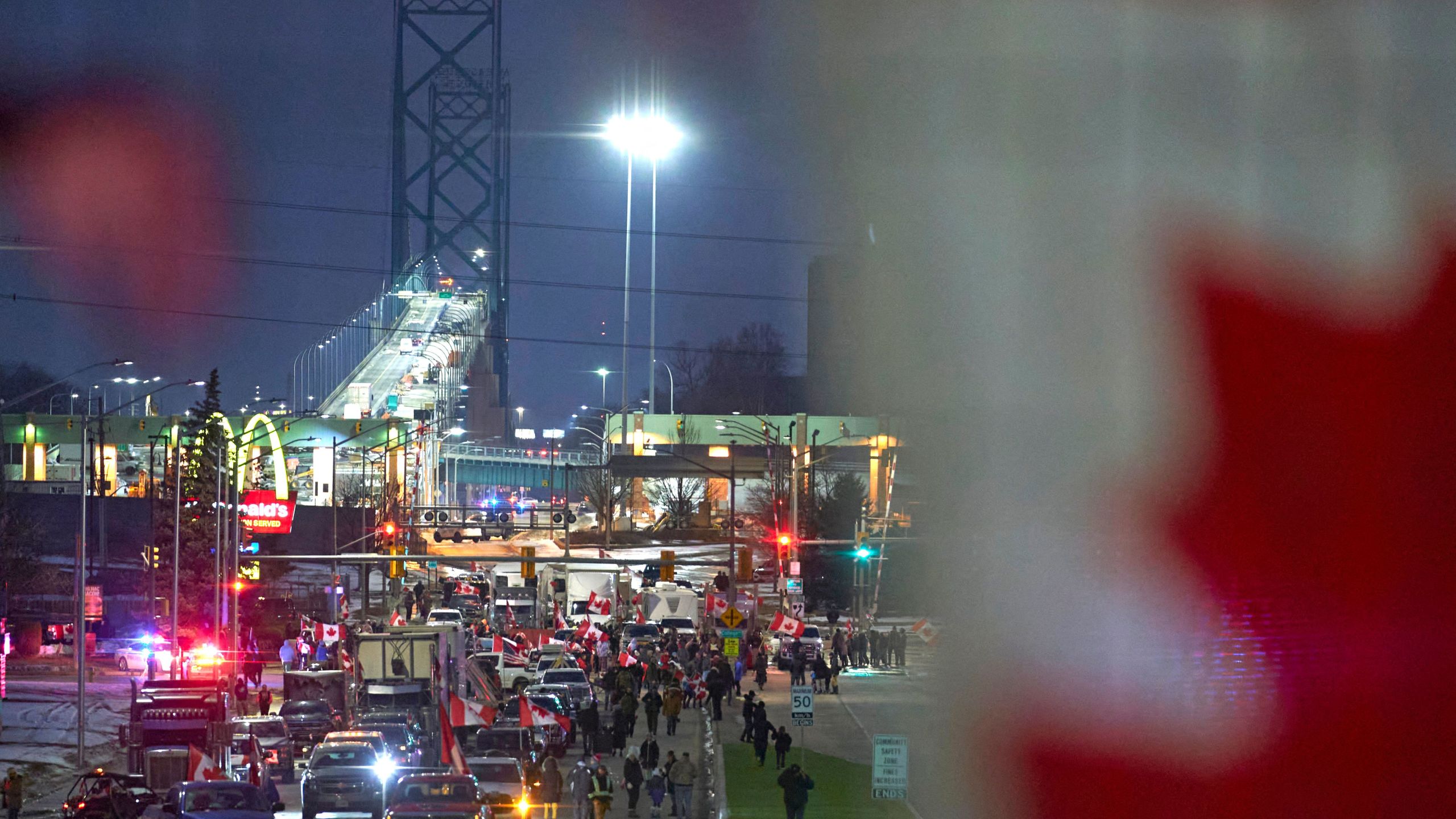 Demonstrators against Covid-19 vaccine mandates block the roadway at the Ambassador Bridge border crossing, in Windsor, Ontario, Canada on February 9, 2022. (Photo by GEOFF ROBINS/AFP via Getty Images)