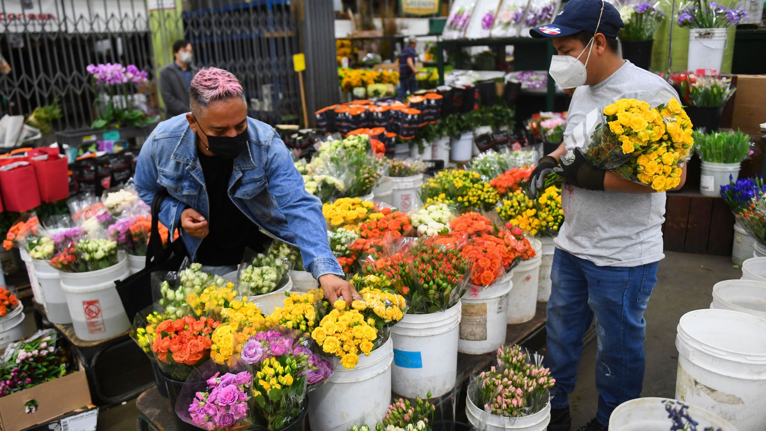 Customers select flowers for sale from a wholesale merchant ahead of the Valentine's Day holiday outside the Southern California Flower Market on Feb. 10, 2022 in Los Angeles, California. (PATRICK T. FALLON/AFP via Getty Images)